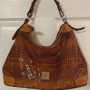 Dooney and Bourke brown satchel. Red interior.